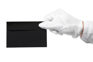 Closeup of a butler holding an envelope. man is unrecognizable