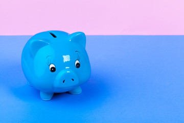 Blue piggy bank money box on bright colored background