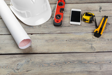 Construction  worker supplies and instruments on wooden background