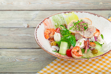 Fresh seafood salad served with prawns and greens