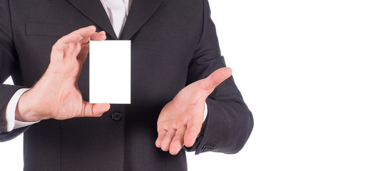 cropped image of a male's hands holding business card. Man wearing in a black suit and white shirt