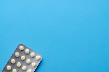 Yellow pills. Panel pills on blue. Medicaments on blue.