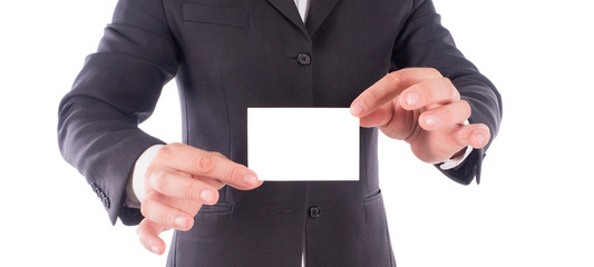 cropped image of a male's hands holding business card. Man wearing in a black suit and white shirt