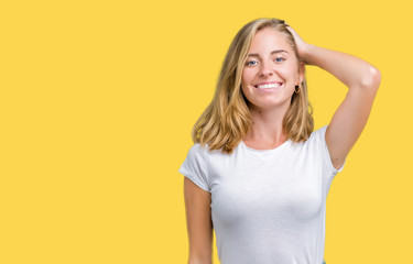 Fototapeta premium Beautiful young woman wearing casual white t-shirt over isolated background Smiling confident touching hair with hand up gesture, posing attractive