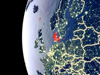 Night view of Denmark from space with visible city lights. Very detailed plastic planet surface.