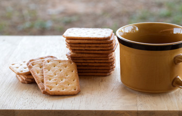 Fototapeta na wymiar Milk cracker cookies Served with hot coffee on wooden desk ,Time break