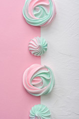 Pink turquoise meringue on a pink background.