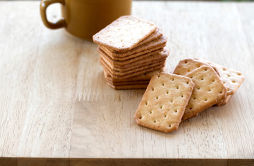Milk cracker cookies Served with hot coffee on wooden desk ,Time break