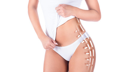 cropped image of a female body in white underwear, showing her waist and hips with arrows and lines. Slimming and fat removing concept