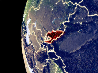 Night view of Kyrgyzstan from space with visible city lights. Very detailed plastic planet surface.