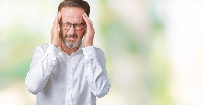 Handsome middle age elegant senior business man wearing glasses over isolated background with hand on head for pain in head because stress. Suffering migraine.
