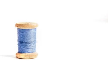 One blue Thread bobbin isolated on white background