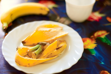 rind of a ripe banana lies on a plate.
