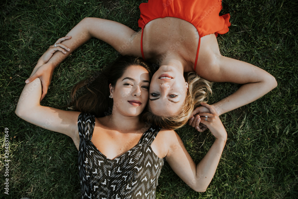 Sticker Lesbian couple lying in the grass