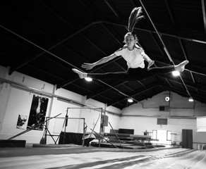 Fototapeta na wymiar Female gymnast practicing at a gymnasium