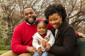 Happy African American family with their baby.