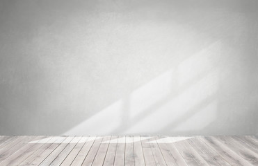 Gray wall in an empty room with a wooden floor