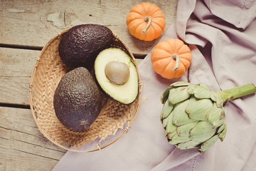 fresh organic artichoke flower, pumpkin and avocado/toned photo