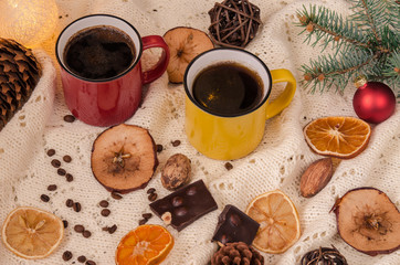 Winter home still life with coffee and Christmas decorations on a white and warm blanket.