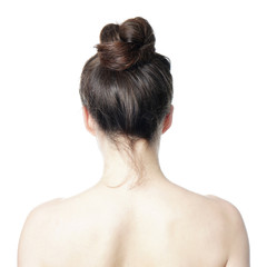head and shoulder back view of young woman with messy bun - undone hair style fashion trend