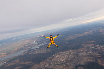 Fototapeta na wymiar Yellowsuit skydiver is in the sky.