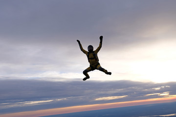 Yellowsuit skydiver is in the sky.