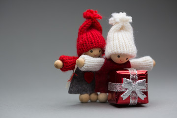 Two dolls in love on Valentines day knitted wear with heart postcard