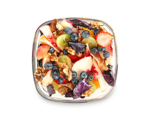 Delicious fresh salad with walnuts on plate, isolated on white