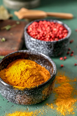 Bowl with turmeric powder on color table
