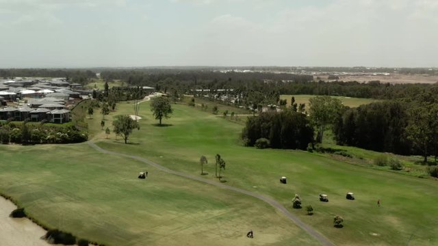 Golfers Driving around the course in Golf Carts