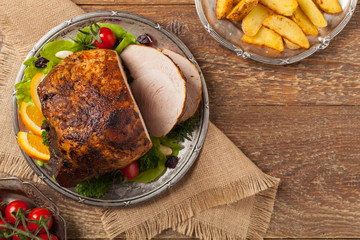 Baked ham, served on an old plate.