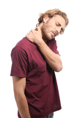 Young man suffering from neck pain on white background