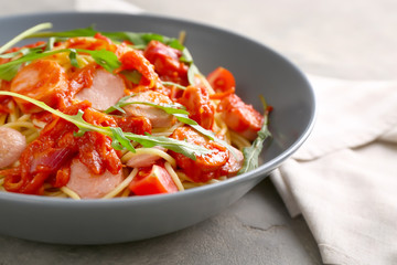 Delicious pasta with sausage and sauce on plate, closeup