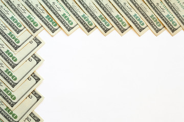 A border of hundred dollar banknotes. Design with copy space.