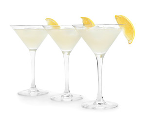 Glasses of fresh lemonade on white background