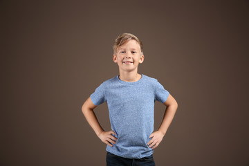 Cute boy in t-shirt on color background