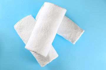 Soft towels on color background