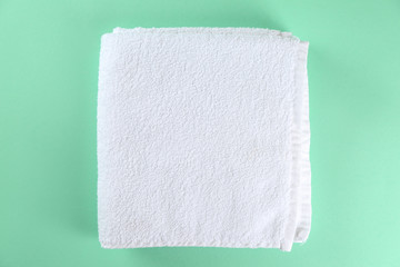 Soft towels on color background