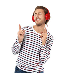 Naklejka premium Young man listening to music on white background