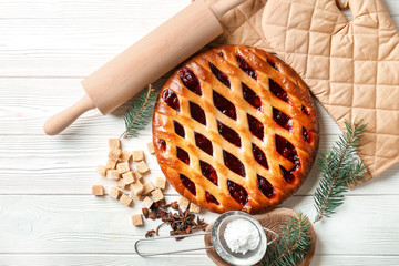Christmas pie with sugar, sieve and rolling pin on table © Pixel-Shot