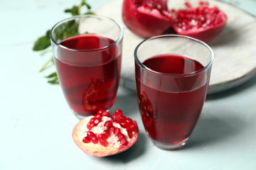 Glasses of pomegranate juice on table