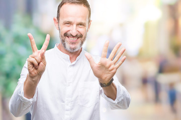 Middle age hoary senior man over isolated background showing and pointing up with fingers number seven while smiling confident and happy.