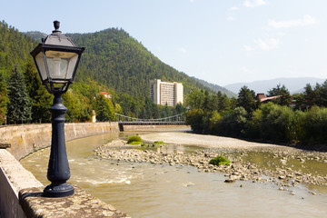 Street lamp with cracked glass on the embankment of the Kura River. © Alexander