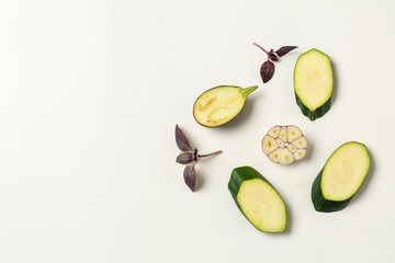 Raw cut zucchini, eggplant and garlic on white background