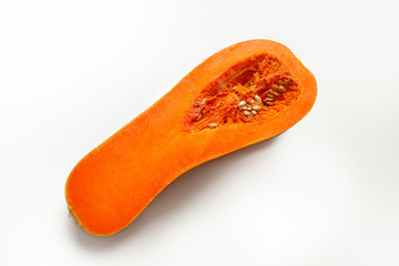 A half of ripe butternut squash pumpkin on a white background. Orange pumpkin with a tail. Close-up.