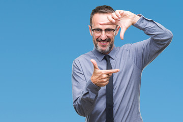 Middle age hoary senior business man wearing glasses over isolated background smiling making frame with hands and fingers with happy face. Creativity and photography concept.