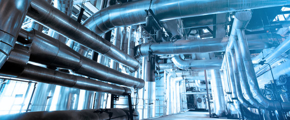 Equipment, cables and piping as found inside of a modern industrial power plant