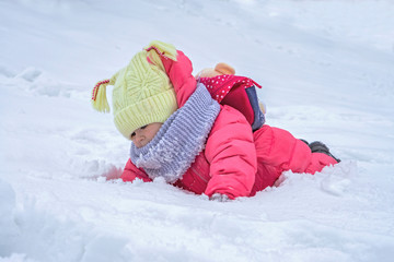 Fototapeta na wymiar Cute child girl on snow. Winter outdoor activities