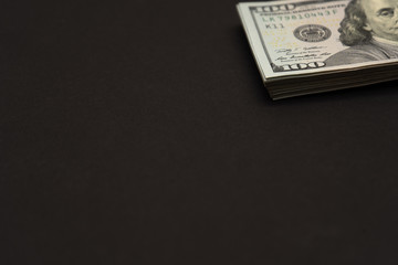 pack of dollars in the upper right on a black background