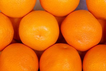 Fresh oranges on the market, view from above. Background, pattern.